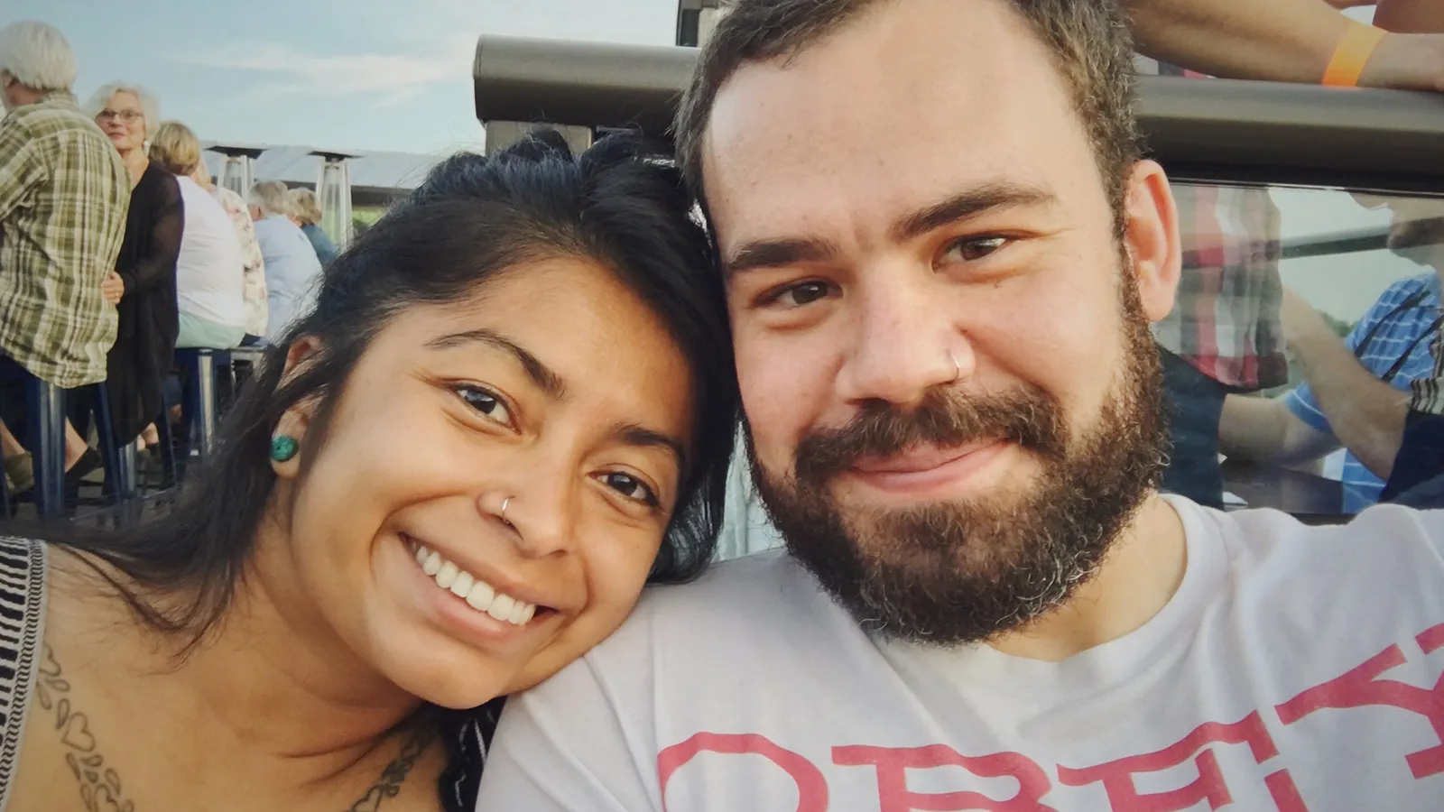 Peter and Consuelo cheek to cheek on a busy rooftop terrace