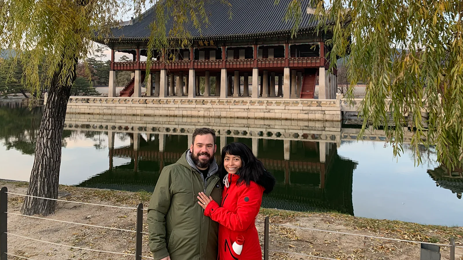 Peter and Consuelo in front of a lakeside pavilion in South Korea